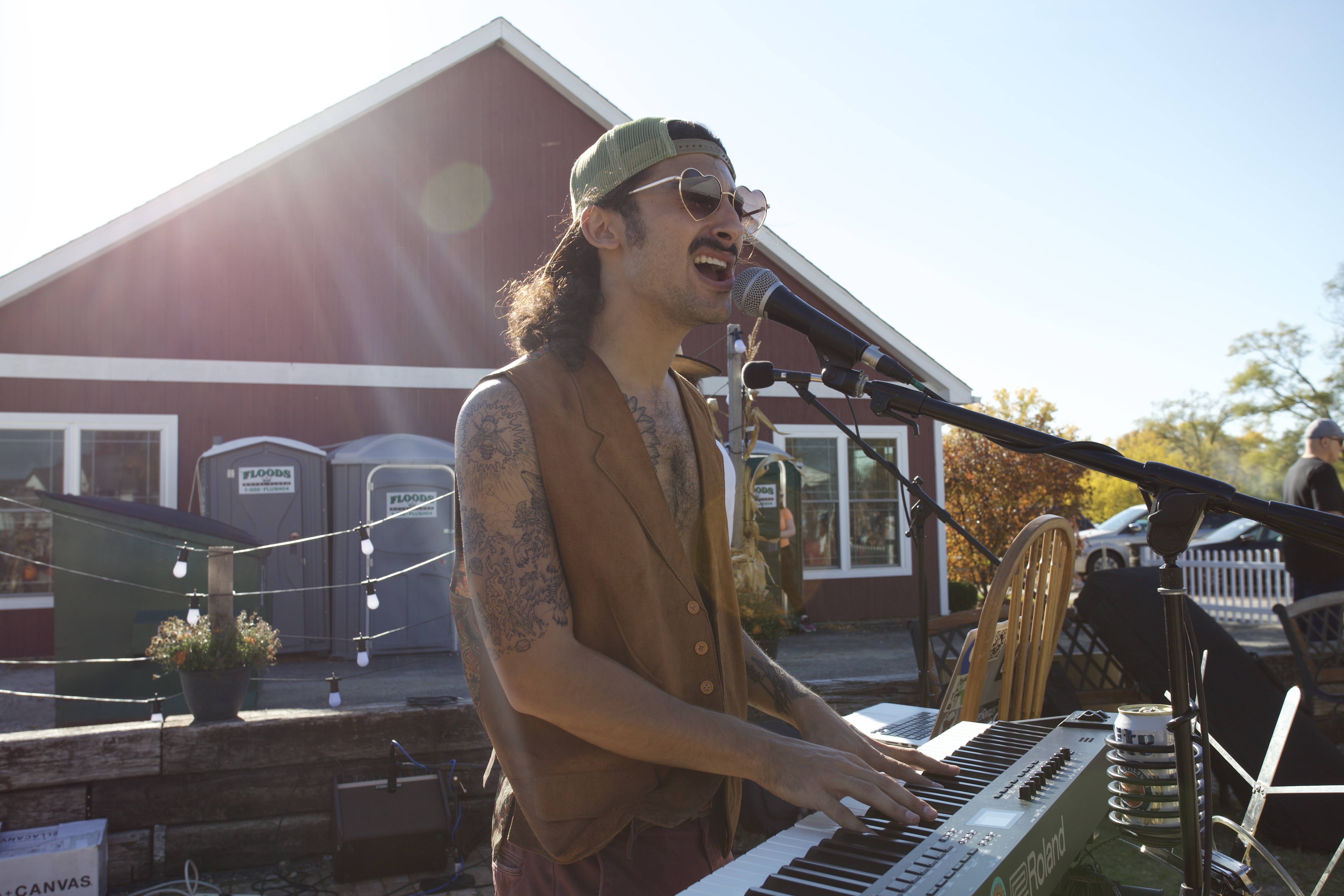 Ross Krakow playing the keyboard and singing into a microphone